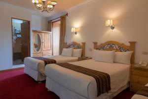 Postel nebo postele na pokoji v ubytování Hotel Rojas Inn