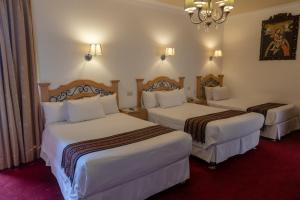 Postel nebo postele na pokoji v ubytování Hotel Rojas Inn