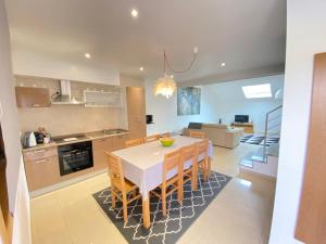 a kitchen and dining room with a table and chairs at Gites Des Sablons in Châtillon-sur-Marne