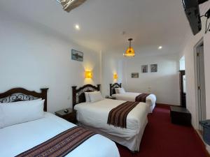 Postel nebo postele na pokoji v ubytování Hotel Rojas Inn
