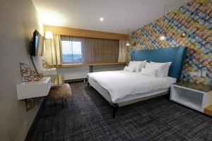 a hotel room with a large bed and a television at Hotel KUNST in Krško +86 photos