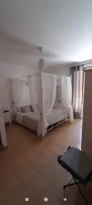 a bedroom with a bed with a canopy and curtains at Appartamento Onda Marina in Polignano a Mare