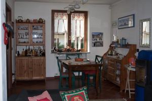 a kitchen with a table and chairs in a room at Trilly Bed & Breakfast in Oulx