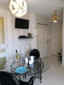 a glass table and chairs in a living room at Cosy Aix in Aix-les-Bains