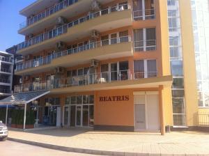 a large yellow building with the words benefits at Beatris Family House in Sunny Beach