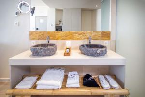 a bathroom with two sinks and towels on a counter at Zahara Beach & Spa by QHotels - Adults Recommended in Zahara de los Atunes