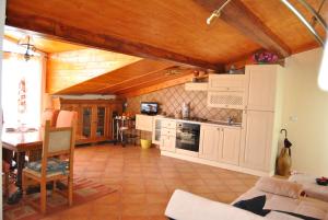 a kitchen with white cabinets and a wooden ceiling at Fondaco Parrino Mare in Letojanni +39 photos