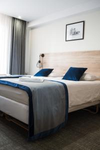 Łóżko lub łóżka w pokoju w obiekcie Gold Hotel