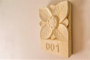 a wooden box with a flower on the wall at Zahara Beach & Spa by QHotels - Adults Recommended in Zahara de los Atunes