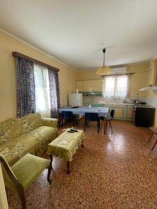 a living room with a couch and a table at Odysseus in Vrontádos