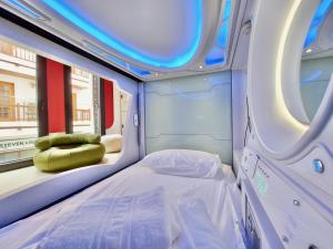 a bed in a room with a round window at Atypicap Capsule Hostel in Puerto de la Cruz