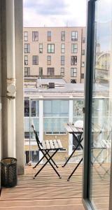 a balcony with a table and chairs on a building at Double Room with Private Balcony in London