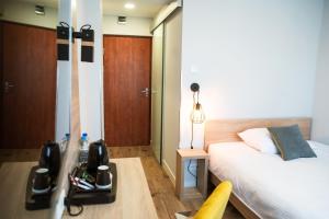 Łóżko lub łóżka w pokoju w obiekcie Gold Hotel