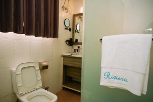 a bathroom with a toilet and a white towel at Riviera Suites in Lagos