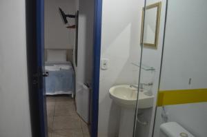 a small bathroom with a sink and a mirror at Pousada Bicho do Mar in Arraial do Cabo +33 photos