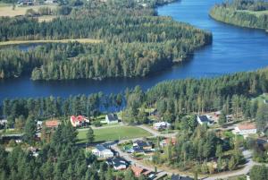 an aerial view of a small town next to a lake at TORPET (Villa Solsidan), Hälsingland, Sweden in Arbrå