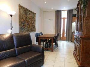 a living room with a couch and a table at Kruitenberg in Bruges