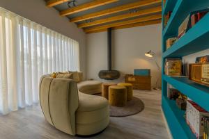 a living room with a couch and a chair at Bacharéis Charming House in Figueira da Foz