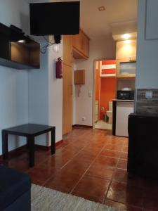 a living room with a table and a kitchen at Casa do Mar in Figueira da Foz