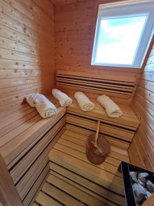 a sauna with three towels and a window at Holiday Spa House Kostanjevec in Velika Gorica