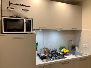 a kitchen with a microwave and a stove top oven at Villa Luminosa in Torre del Lago Puccini
