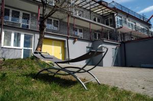 a bench sitting in the grass in front of a building at Słoneczne Tarasy in Mikołajki