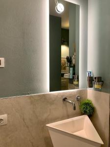 a bathroom with a sink and a mirror at Villa Luminosa in Torre del Lago Puccini