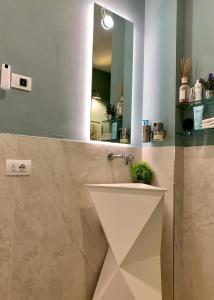 a bathroom with a sink and a mirror at Villa Luminosa in Torre del Lago Puccini