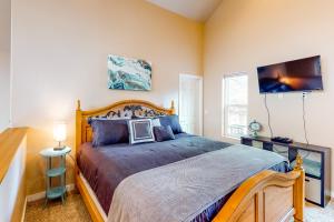 a bedroom with a large bed with a wooden frame at CDA Lakefront Retreat in Harrison