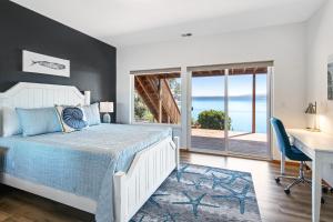 a bedroom with a bed and a desk and a window at Hook & Cook Beach House in Brinnon