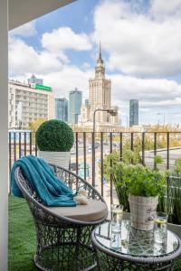 a balcony with a table and a view of a city at GLAM APARTMENTS city center in Warsaw