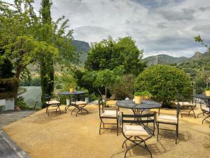 a patio with tables and chairs and a lake at Posada Real Quinta de la Concepción in Hinojosa de Duero