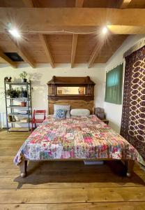 a bedroom with a bed with a quilt on it at Cozy cottage in countryside close to Tbilisi in Dushetʼi