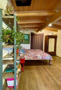 a room with a bed and a wooden floor at Cozy cottage in countryside close to Tbilisi in Dushetʼi