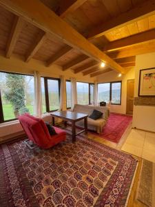 a living room with a table and a couch at Cozy cottage in countryside close to Tbilisi in Dushetʼi
