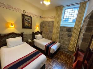 Postel nebo postele na pokoji v ubytování Hotel Rojas Inn