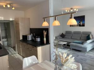 a kitchen and a living room with a couch at Mariposa 2 in Bad Harzburg