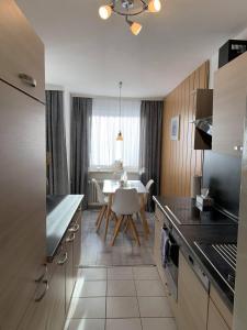 a kitchen with a table and a dining room at Mariposa 2 in Bad Harzburg +14 photos