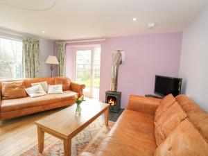 sala de estar con 2 sofás y chimenea en Puccini en Pitlochry