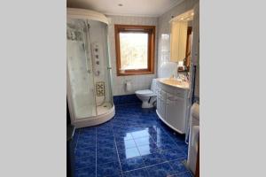 a bathroom with a tub and a toilet and a sink at Marikollen, spacious appartment with sunny veranda in Kristiansand +14 photos