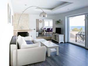 a living room with a white couch and a table at Apartments Villa Sofia in Crveni Vrh