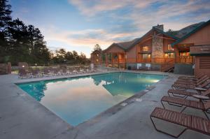 a large swimming pool with chairs and a house at WorldMark Estes Park in Estes Park