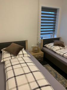 a bedroom with two beds and a window at Mariposa 4 incl Pool & Sauna in Bad Harzburg