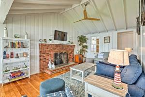 a living room with a couch and a fireplace at Waterfront Portsmouth Cottage 8 Mi From Newport! in Portsmouth