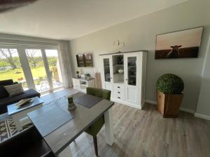 a living room with a table and a couch at Strandnest in Wyk auf Föhr