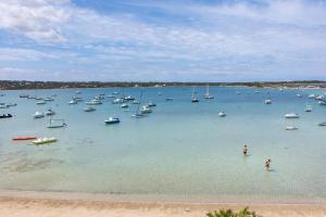 a large body of water with boats in it at Hostal la Savina in La Savina