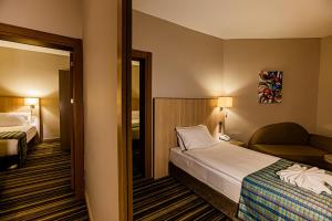 a hotel room with a bed and a chair at Mustafa Cappadocia Resort in Urgup +106 photos