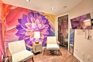 a room with two chairs and a large flower mural at Denver Apartment Walk to Cheesman Park and 6th Ave! in Denver