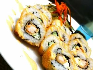 a pile of sushi on a white plate at TOGA GUEST HOUSE in Port Antonio