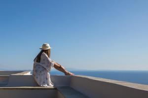 a woman sitting on a boat looking out at the ocean at Villa Adele in Arnados